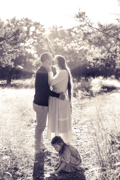Maternity family photography with daughter playing