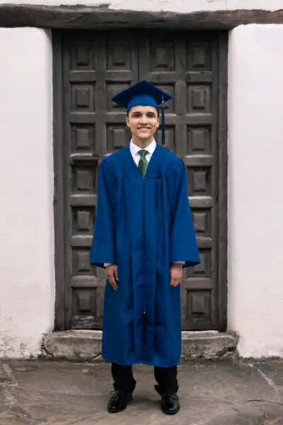 Senior Boy Standing Cap And Gown Photo Idea