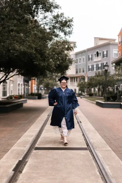 Senior Girl Walking With Cap And Gown Photo Pose